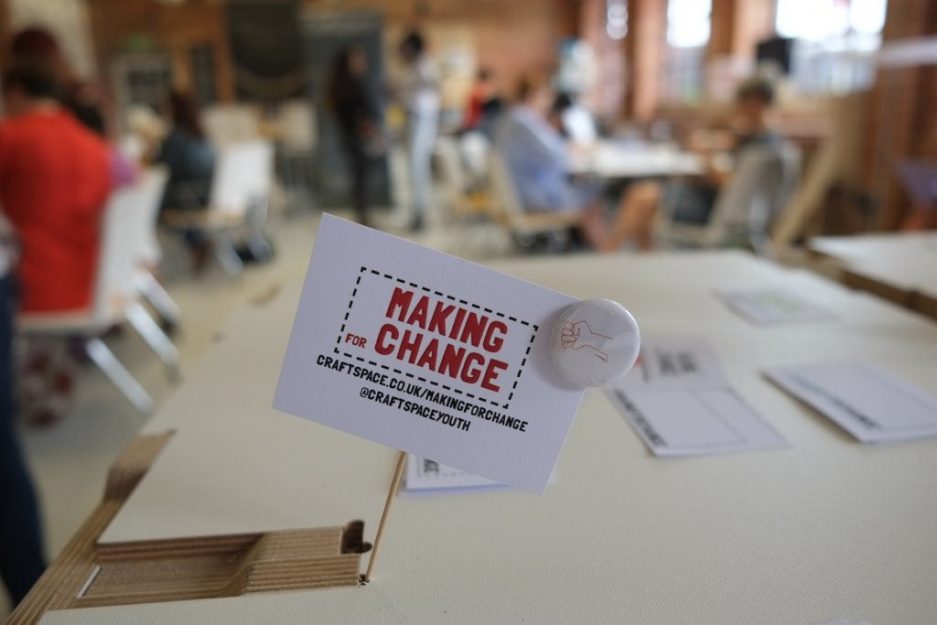 small card "Making for Change" with a pin badge of red stitched fist design